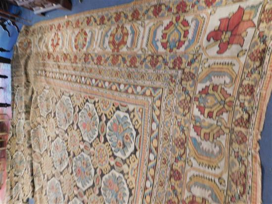 A large Indian carpet, circa 1910, 16ft 1in x 21ft 4in. (652cm x 491cm), fragment 5ft 11in. x 3ft 6in.